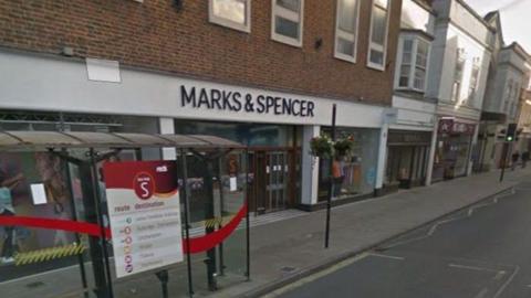Image of Marks and Spencer in Salisbury. The sign is white with black letters. 