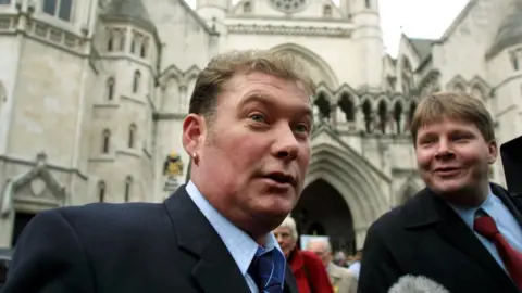 Getty Images Steven Thoburn, one of the so-called metric martyrs, leaves the Royal Courts of Justice in London in 2001