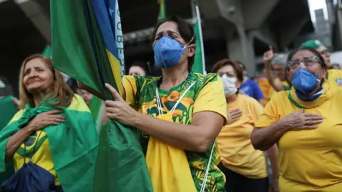 Reuters Supporters of Brazilian President Jair Bolsonaro participate in a demonstration in Sao Paulo on 15 March