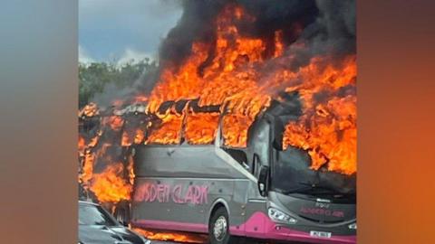 a bus engulfed in flames