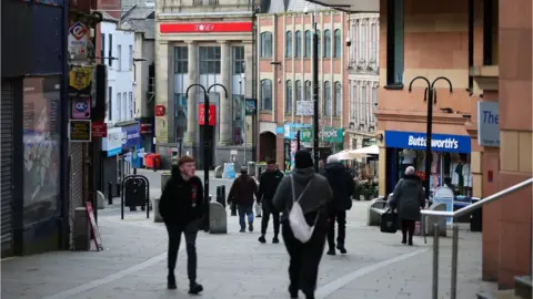 EPA People walk through the town centre in Rochdale, Britain,