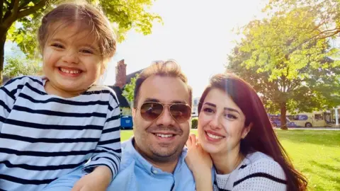 Mohamed Hady Taresh Mohammed with his daughter Alice and wife Jollanar