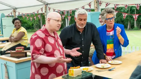 C4/Love Productions/Mark Bourdillon Matt Lucas with Paul Hollywood, Prue Leith and contestants Hermine and Marc