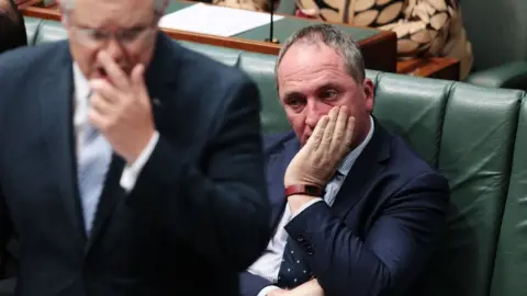 Getty Images Barnaby Joyce holds his hand to his face while sitting in parliament