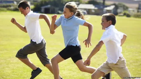 Science Photo Library Older children racing