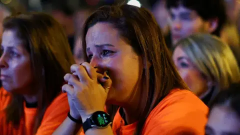 Reuters A woman reacts as relatives and supporters of hostages kidnapped on the deadly October 7 attack by Palestinian Islamist group Hamas, rally for their release, after a temporary truce between Israel and the Palestinian Islamist group Hamas expired, in Tel Aviv, Israel, December 2, 2023. REUTERS/Athit Perawongmetha