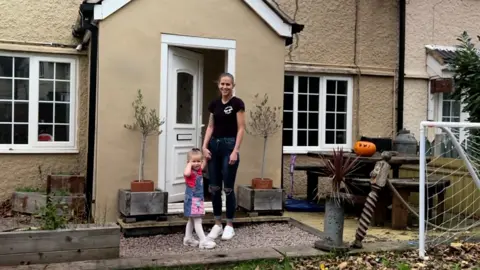 A woman outside a house