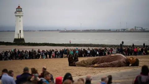 Getty Images people watch big giant on beach