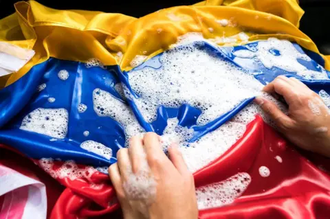 Getty Images Model's hands washing a Colombian flag