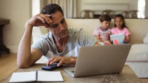 Getty Images Man deals with debt