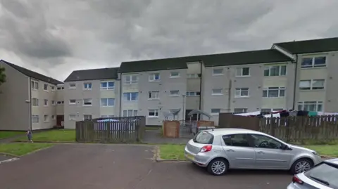 A row of flats with overcast skies above them