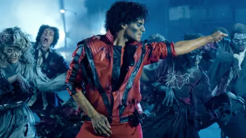 Universal Jaafar Jackson as Michael Jackson in the musical biopic Michael, wearing a red jacket as he recreates the music video for Thriller