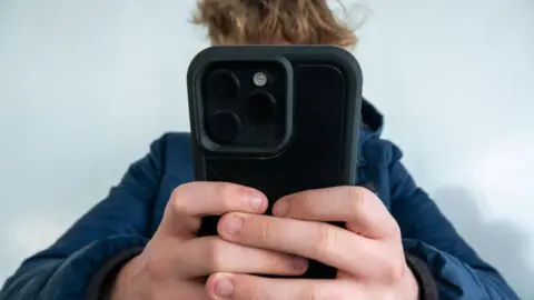 Getty Images Person holds Apple iPhone