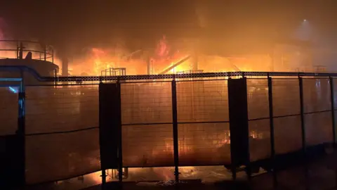 Fire behind a fence at Tata Steel plant.