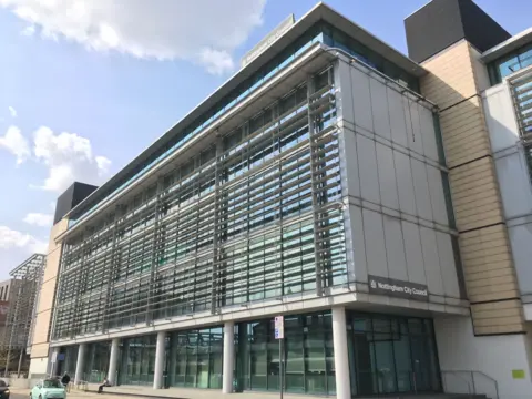 A large building - loxley house. There is a sign on the front saying nottingham city council and the building has large windows with grey and beige panelling.