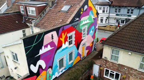 Jake Davis/Upfest A drone shot from above of a giant colourful street art mural on St John's Lane in Bristol as part of Upfest Presents