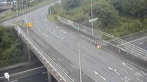 A CCTV image of the motorway bridge over the M62, it shows damage to the barrier