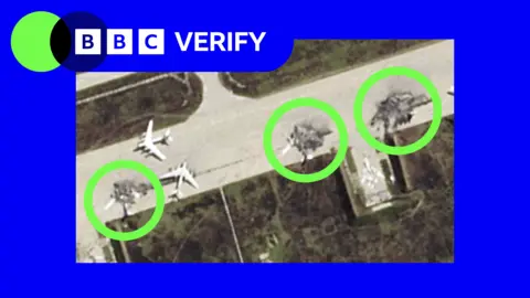A satellite image showing damaged Russian planes on a runway. Three damaged jets are circled in the photo, which is imposed over the BBC Verify colours and accompanied by the BBC Verify logo in the top left corner. 