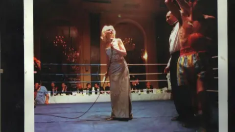 Charlotte Howard A woman on a stage with blonde hair and a dress