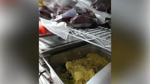 Coventry City Council Raw meat in bags above a steel tray on rice in a kitchen.