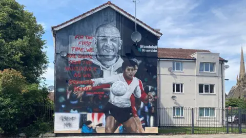 Mural featuring footballer Howard Gayle on the side of building in Liverpool.