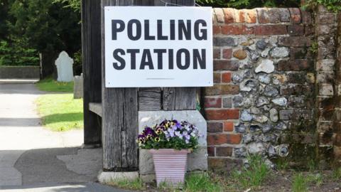 Polling station sign at village location