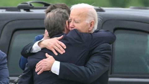 Hunter and Joe Biden embrace on the tarmac in Delaware