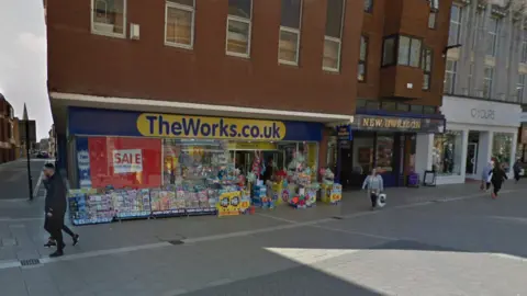 Google A parade of shops on a pedestrianised street - The Works, New Horizon and Yours