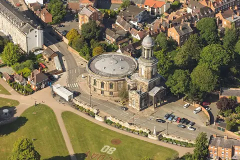 Getty Images An aerial view of Saint Chad's church showing it's circular building, church tower and car park amid surrounding houses