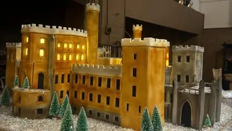 Belvoir Castle A cake version of Belvoir Castle, a brown and grey building with several turrets.