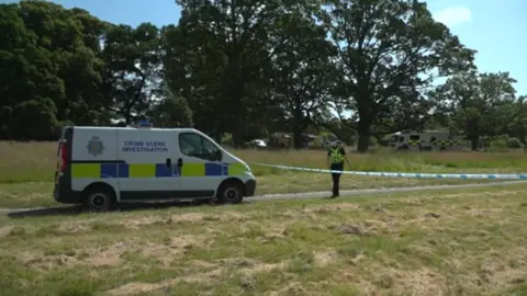 BBC Police vehicle at search scene