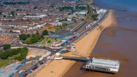 North East Lincolnshire Council  An aerial view of Cleethorpes with the beach and promenade and urban area to the left