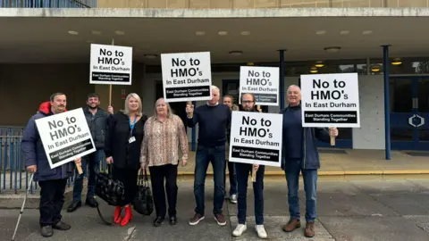 LDRS Eight members of East Durham Communities Standing Together group standing outside Durham County Hall and holding signs which read No to HMO's in East Durham.