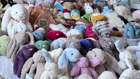 A huge pile of Jellycat toys, many of which resembling bunny rabbits