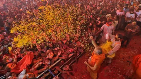 Getty Images Devotees celebrate with colours, a day before the festival of 'Holi', at Govind Dev Ji Temple, in Jaipur, Rajasthan, India,Thursday, March 17, 2022.