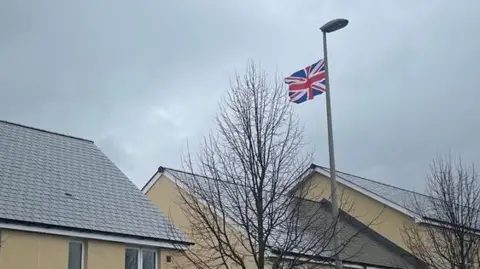 A row of houses in Cranbrook with a Union flag on a lamppost