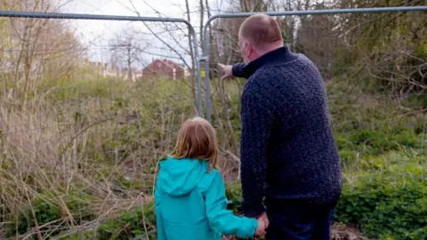 Good Law Project Man and girl looking at the site in Greenfields, Shrewsbury