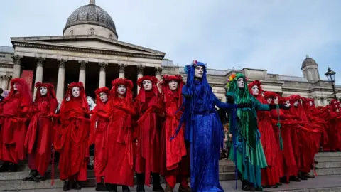 Getty Images Climate activists protest on the steps of the National Gallery in Trafalgar Square