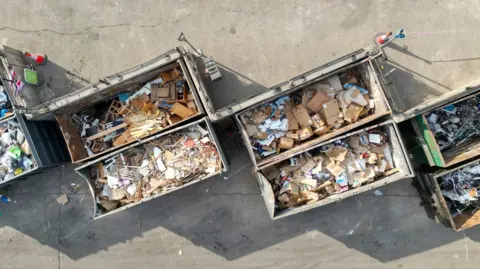 Overhead aerial view of containers full of different recycled waste materials.