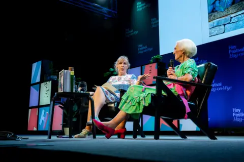 Adam Tatton-Reid/Hay Festival Mel and Dame Mary sat on chairs side by side to each other on stage at the Hay Festival. 