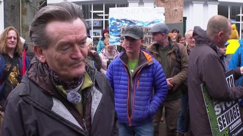 Feargal Sharkey with protesters behind him