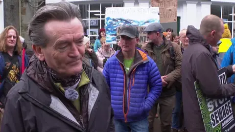 BBC Feargal Sharkey with protesters behind him