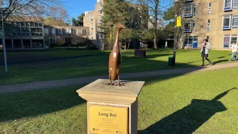 A bronze statue of a duck.