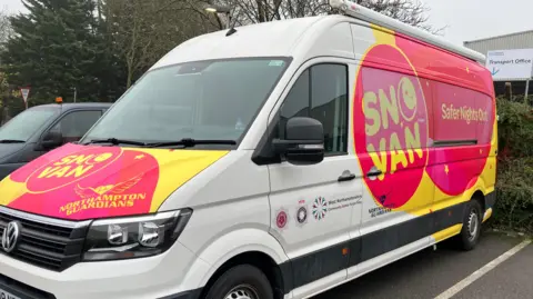 Sam Read/BBC A van with bright yellow and pink colours on the side