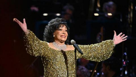  Dame Shirley Bassey performs on stage accompanied by The Royal Philharmonic Concert Orchestra during The Sound of 007 in concert at The Royal Albert Hall on October 04, 2022 in London, England