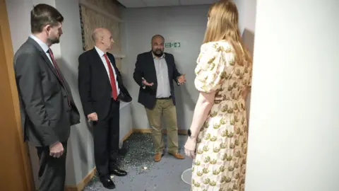 Reuters Deputy Prime Minister Angela Rayner, Minister of State at the Ministry of Housing, Communities and Local Government Jim McMahon and Secretary of State for Defence John Healey visit a Holiday Inn Express where cleanup efforts are underway