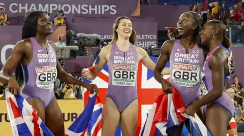 A group of four women celebrate winning the Women's 4x100m Relay Final at the European Athletics Championships 2024.