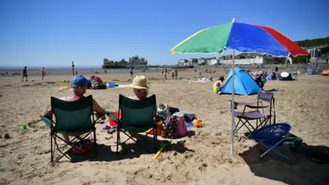 PA Media Sunbathers enjoy the hot weather at Weston-super-Mare on Wednesday 20 May