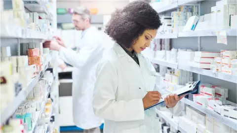 Getty Images Pharmacists checking medicines