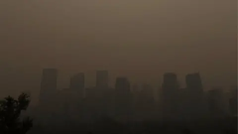 Arnaud Lebon via Reuters A haze from the wildfires in British Columbia descends on Calgary, Alberta
